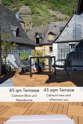 a picture of a patio with a table and chairs at Terrasse der Ruhe im Alten Winzerhaus am Calmont in Bremm