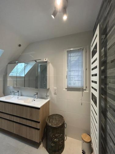 a bathroom with a sink and a mirror at Ty avel in Crozon