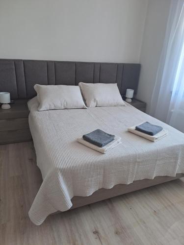 a bedroom with a bed with two towels on it at MarVi home in Ruse