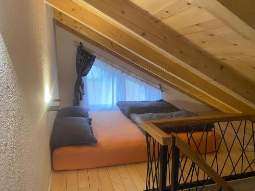 a room with two beds and a window at Dutaka Boutique Villa with Pool in Polje Ostružnica
