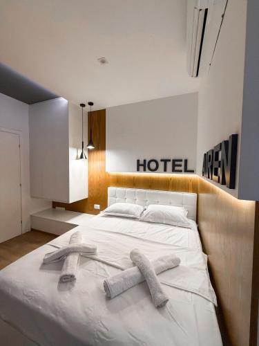 a bedroom with a bed with two towels on it at Airen Hotel Velipoje in Velipojë