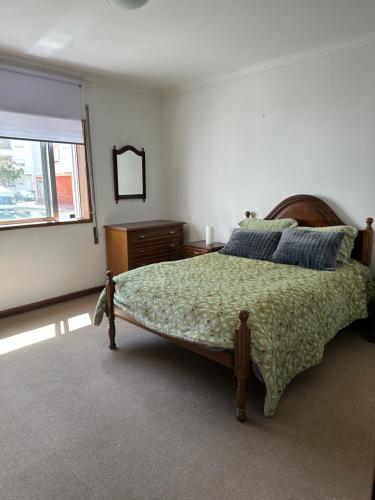 a bedroom with a large bed and a window at Cantinho da Mariana in Moledo