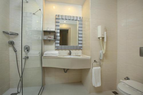 
a bathroom with a sink, toilet and bathtub at Mandarin Resort & Spa in Bodrum City
