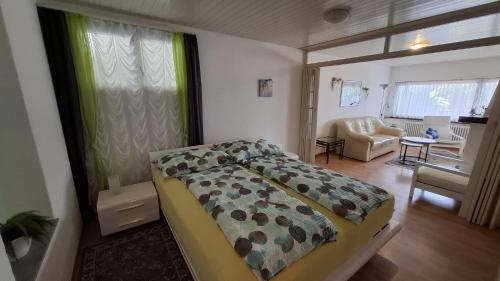 a bedroom with a bed and a living room at Appartamenti Villa Colibri in Neggio