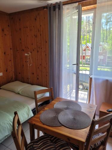 a dining room with a table with two hats on it at Pod Sosnami 46 in Pobierowo