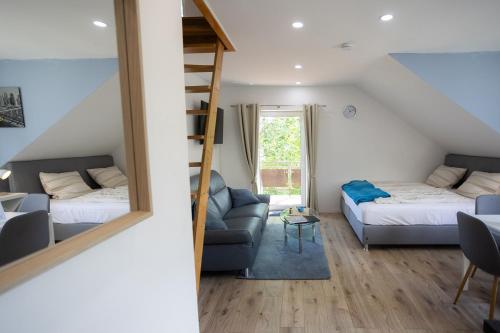 a living room with a bed and a couch at Reload Apartments - FeWo1 im Remmeker Feld in Bad Arolsen