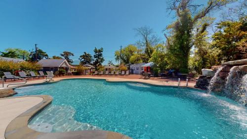 a swimming pool with a waterfall in a resort at The Cape in Cape May