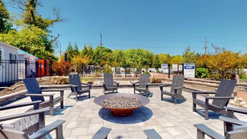 a patio with chairs and a table with a fountain at The Cape in Cape May