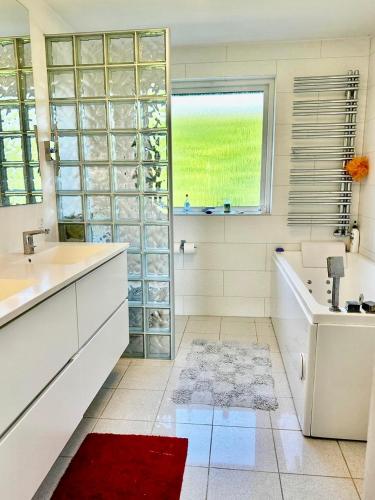 a white bathroom with a tub and a sink at Chatka in Tappernøje