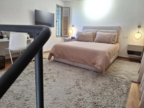 a bedroom with a bed with a black rail at La villa de mamie in Dar Ito Lahssene