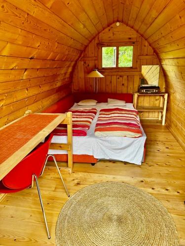 a bedroom with a bed in a wooden cabin at Chatka in Tappernøje