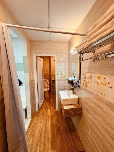 a bathroom with a sink and a mirror at Nice Hotel Buôn Ma Thuột in Buon Ma Thuot