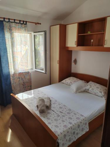 a bedroom with a bed with a towel on it at Apartman Ferri 3 in Vrbanj