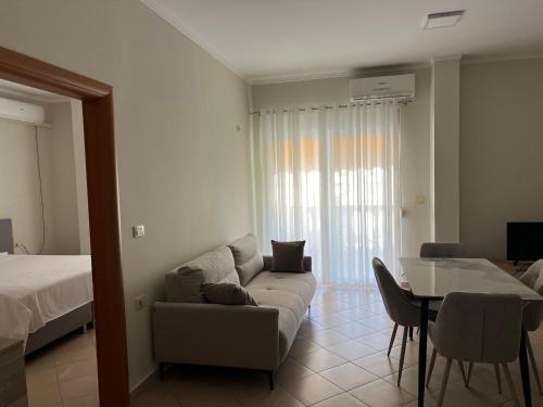 a living room with a couch and a table at Garden view apartment in Karpen