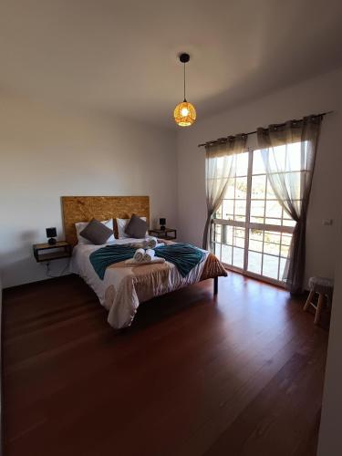 a bedroom with a bed and a large window at Dotty's House in Gaula