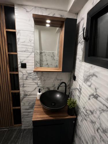 a bathroom with a black sink and a mirror at Vikendica Ema in Šipovo