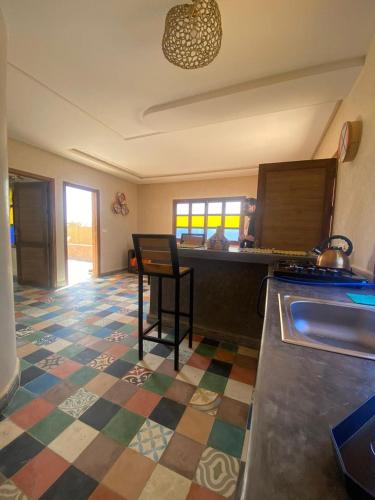 a kitchen with a table and a counter top at Le domaine de Koujane in Oulad el Guern