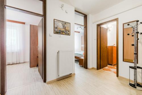 an apartment with a hallway with a radiator and a bedroom at Guesthouse Sobe Silva in Tolmin