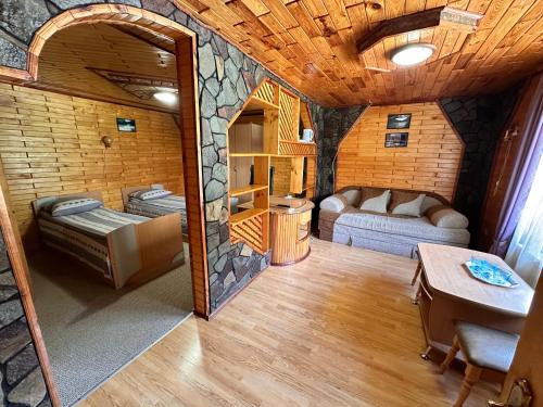 a room with a living room with a couch and a table at Smerekova Hata in Yablunytsya