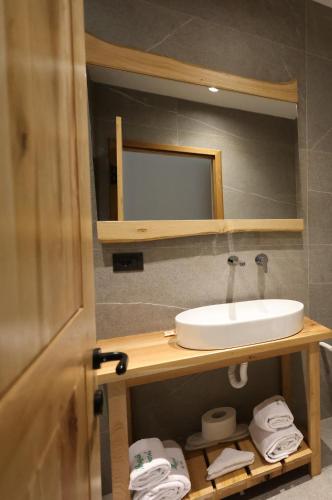 a bathroom with a sink and a mirror at Mugull Agrotourism Hotel in Tirana