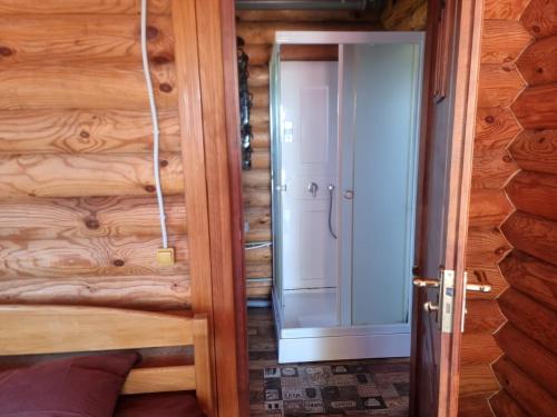 a door leading into a room with a wooden wall at Бухта Вікінга in Szack