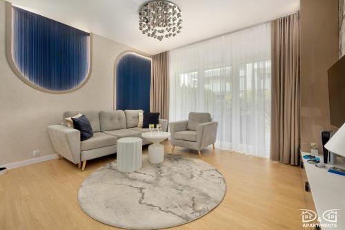 a living room with a couch and a table at Apartament POGO LOVERS in Pogorzelica