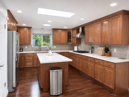 a kitchen with wooden cabinets and white counter tops at Bellevue Pet friendly Home Fenced Yard in Bellevue