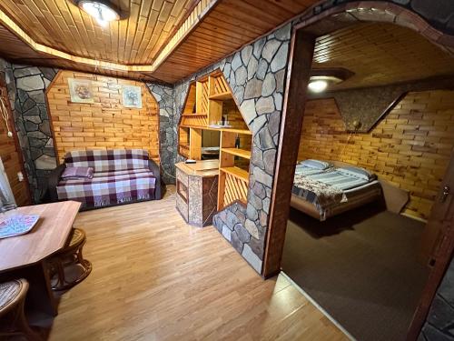 an overhead view of a cabin with a bed and a couch at Smerekova Hata in Yablunytsya