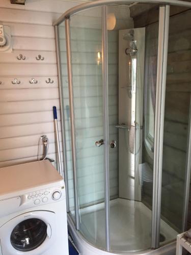 a shower with a washing machine in a bathroom at Senja, Villa View in Senja