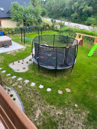 a trampoline in the grass in a backyard at Chalet pri studenom potoku in Stará Lesná