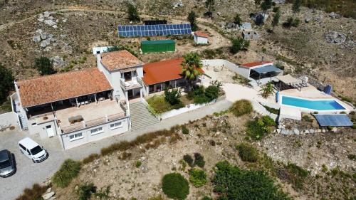 an aerial view of a house with a swimming pool at Quinta O Ninho in Monchique
