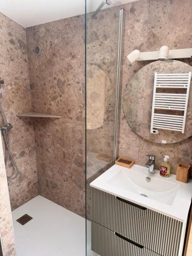 a bathroom with a sink and a shower at Maison Milani Centuri in Centuri