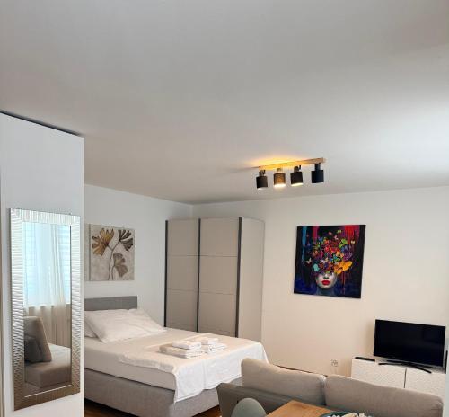 a white room with a bed and a couch at Piti in Lucerne