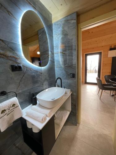 a bathroom with a sink and a mirror at Kozara Panoramic Resort in Bosanska Gradiška