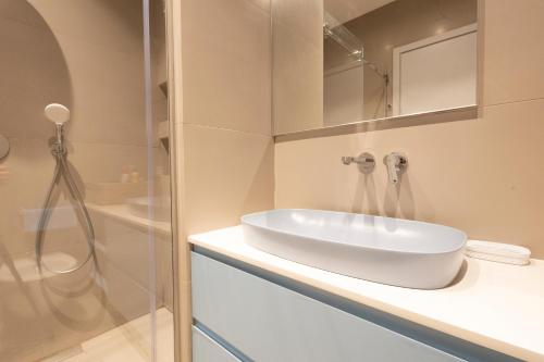 a bathroom with a white sink and a shower at Aria apartment 2 in Dhërmi