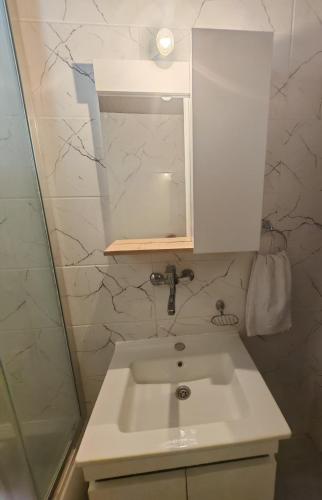 a bathroom with a sink and a mirror at Apartman Dona in Petrovac na Moru
