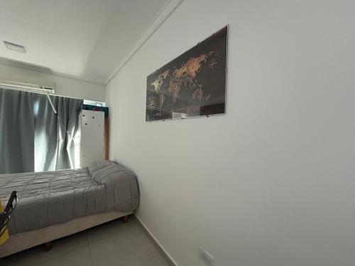 a bedroom with a bed and a painting on the wall at Shackleton in Wilde