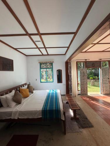 a bedroom with a large bed and a window at Lobo's Retreat in Kurunegala