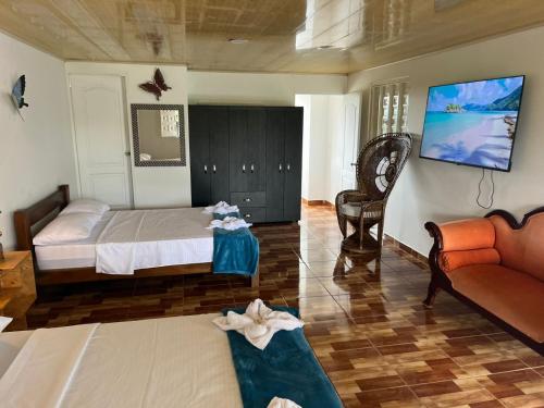 a living room with a bed and a couch at Hotel y Club Pueblito Quindiano Montenegro in Montenegro
