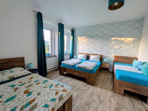 a bedroom with two beds and a bed and a window at Olsinky in Ústí nad Labem