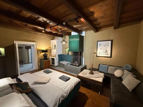 a large room with two beds and a couch at Ateliér Kráľovič in Hokovce