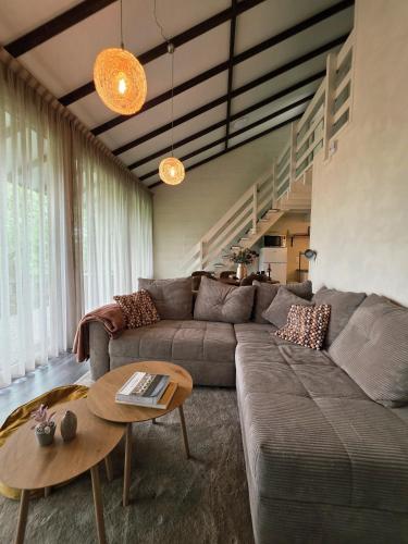 a living room with a couch and a table at Slow Stay Coo in Stavelot