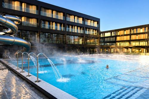 a large swimming pool in front of a building at L'Instant Saint-Epvre Charm & Old Town in Nancy