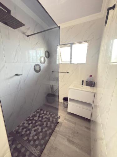 a bathroom with a shower and a sink at Palmview in Bulawayo