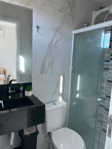 a bathroom with a toilet and a glass shower at Flat no Alto de Bezerros Casa 7 in Bezerros