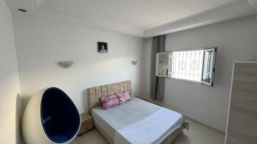 a small bedroom with a bed and a window at House in Djerba s1 in Midoun