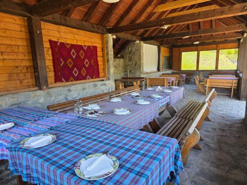 a dining room with long tables in a building at Katun Komovi in Andrijevica