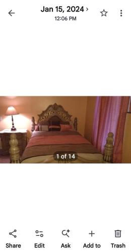 a bedroom with a bed with a clock on it at Nijsha Enterprise in Jonesboro