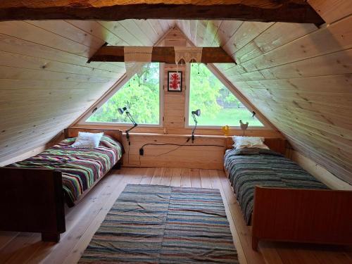a room with two beds in a attic at Józefowa Chata in Rudnik