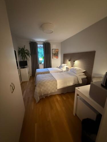 a bedroom with a large bed and a window at Morfslottet in Gothenburg